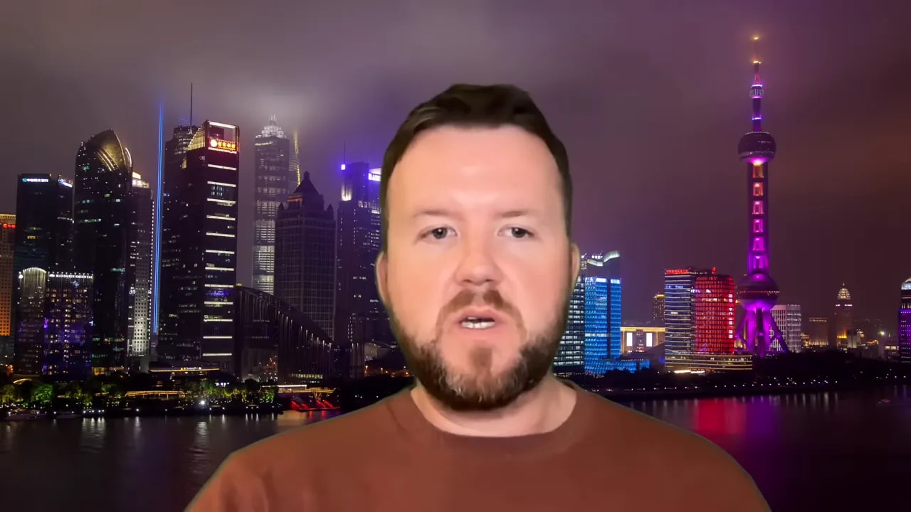 Host explaining national security concerns around AI distillation with city skyline background