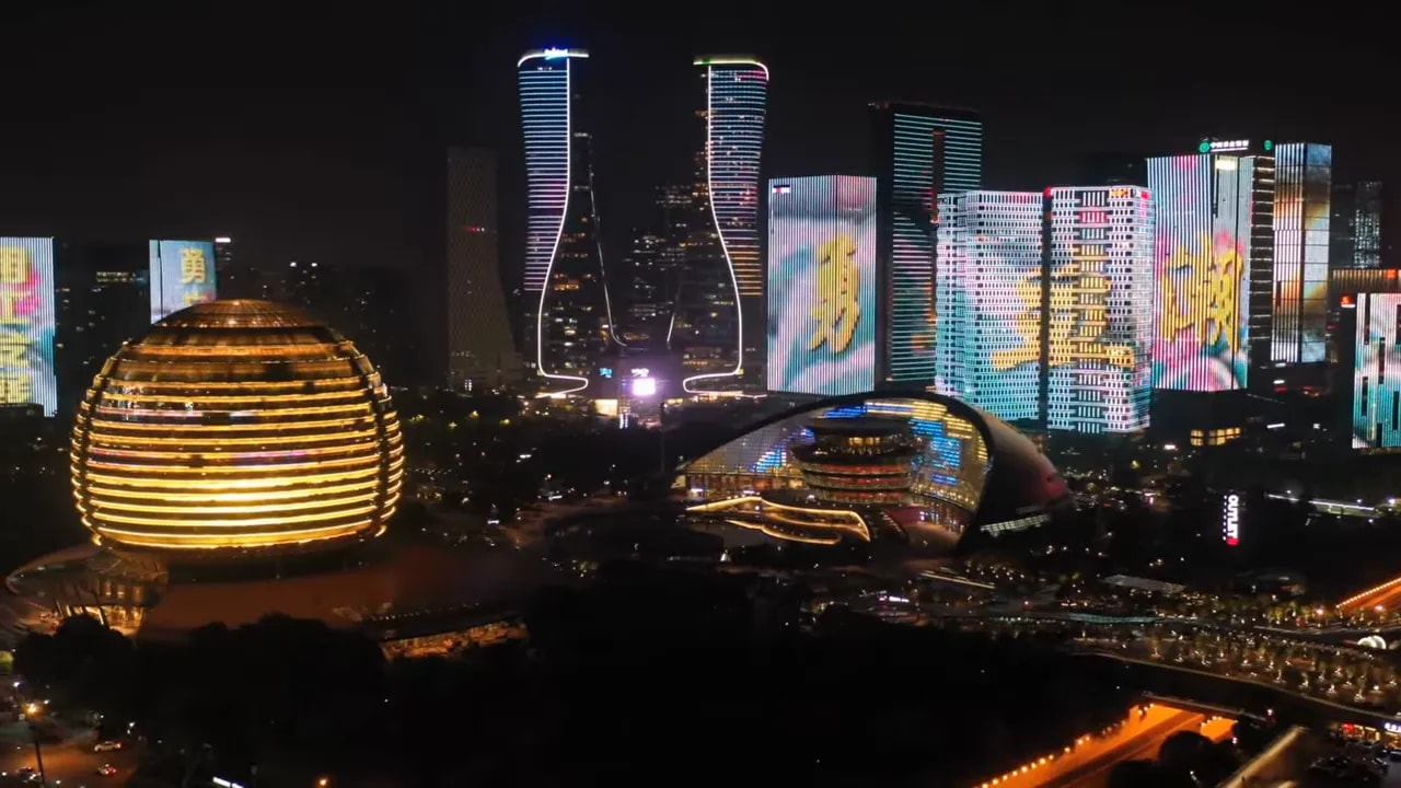 Night city skyline with illuminated towers representing rising US-China tensions