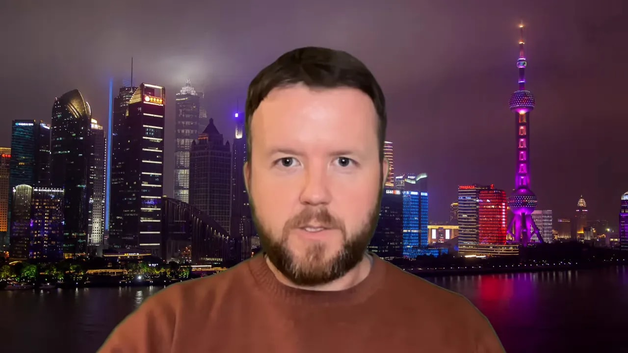 Presenter with Shanghai skyline backdrop discussing why transparency is crucial for foot-and-mouth disease containment