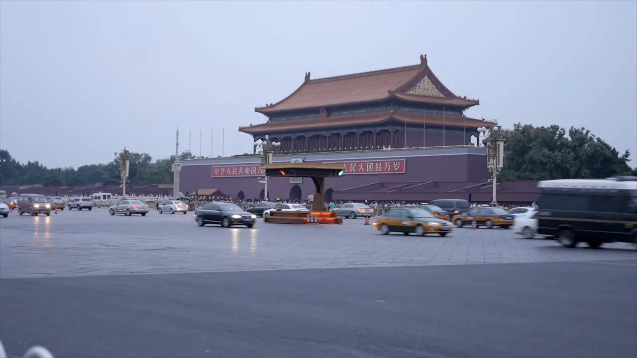 Tiananmen Gate Beijing with vehicles including taxi-like cars during a ceremonial event