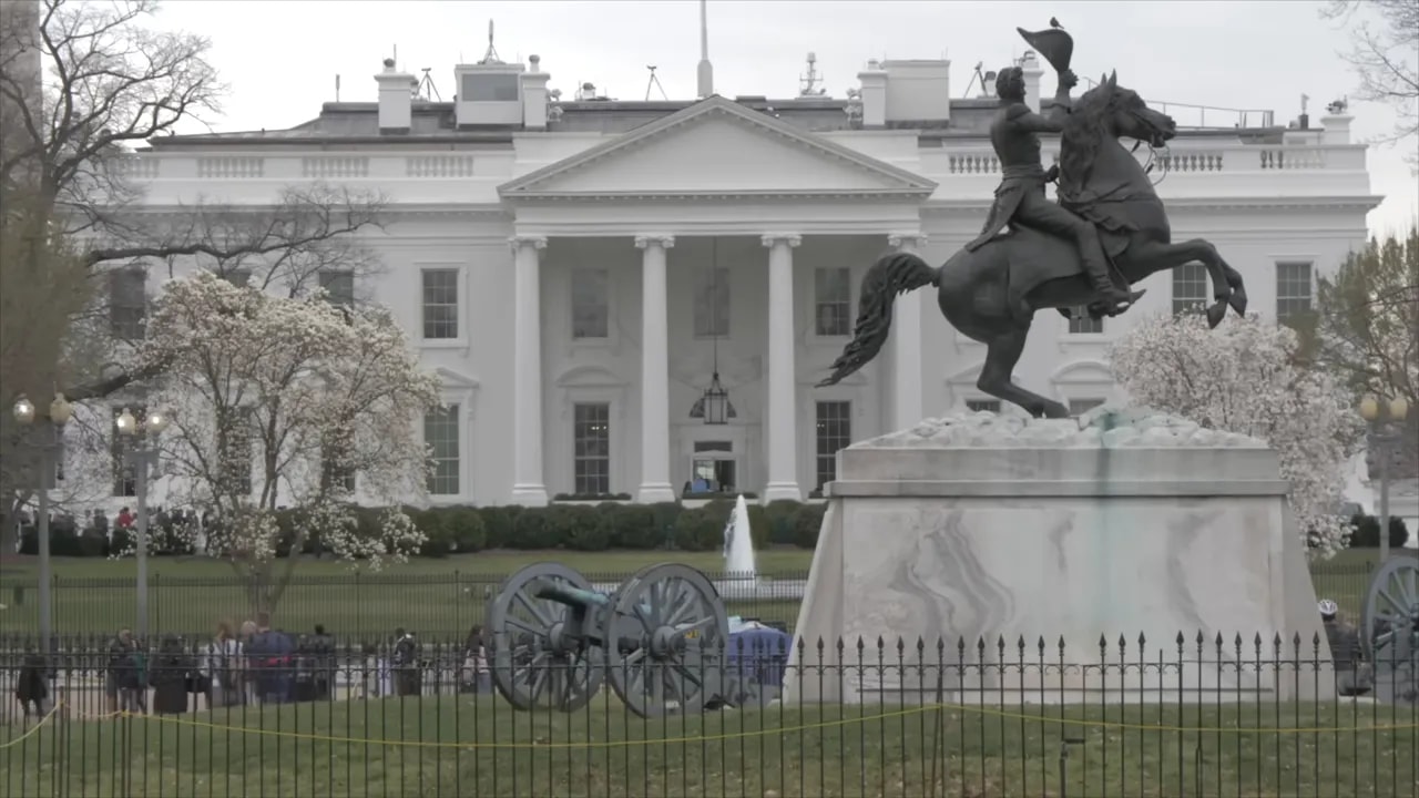 White House building with equestrian statue in foreground